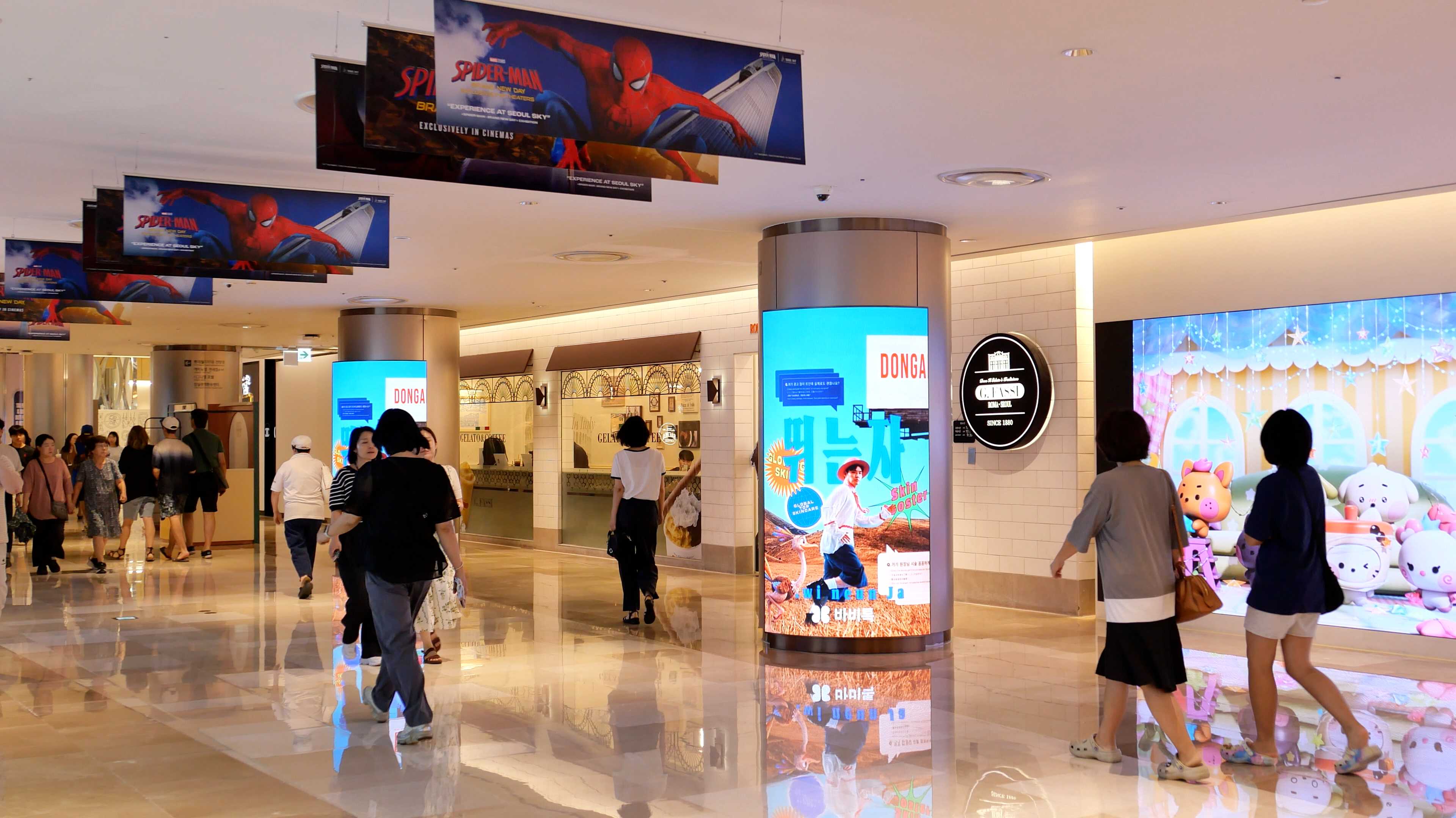 BABITALK skin booster creative on a curved digital column in a Lotte World Mall walkway, Jamsil