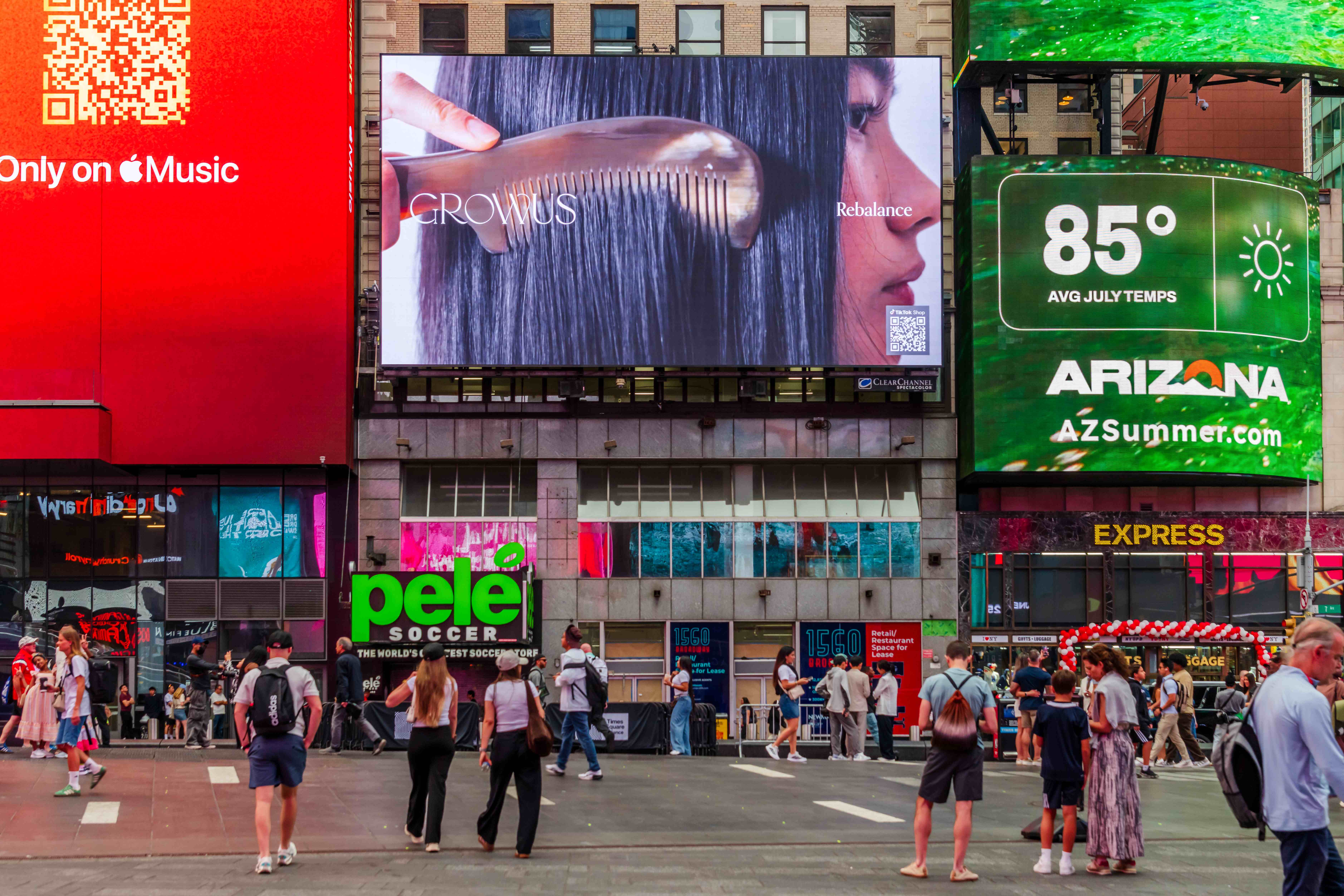GROWUS "Rebalance" creative showing a comb through dark hair on the Times Square billboard