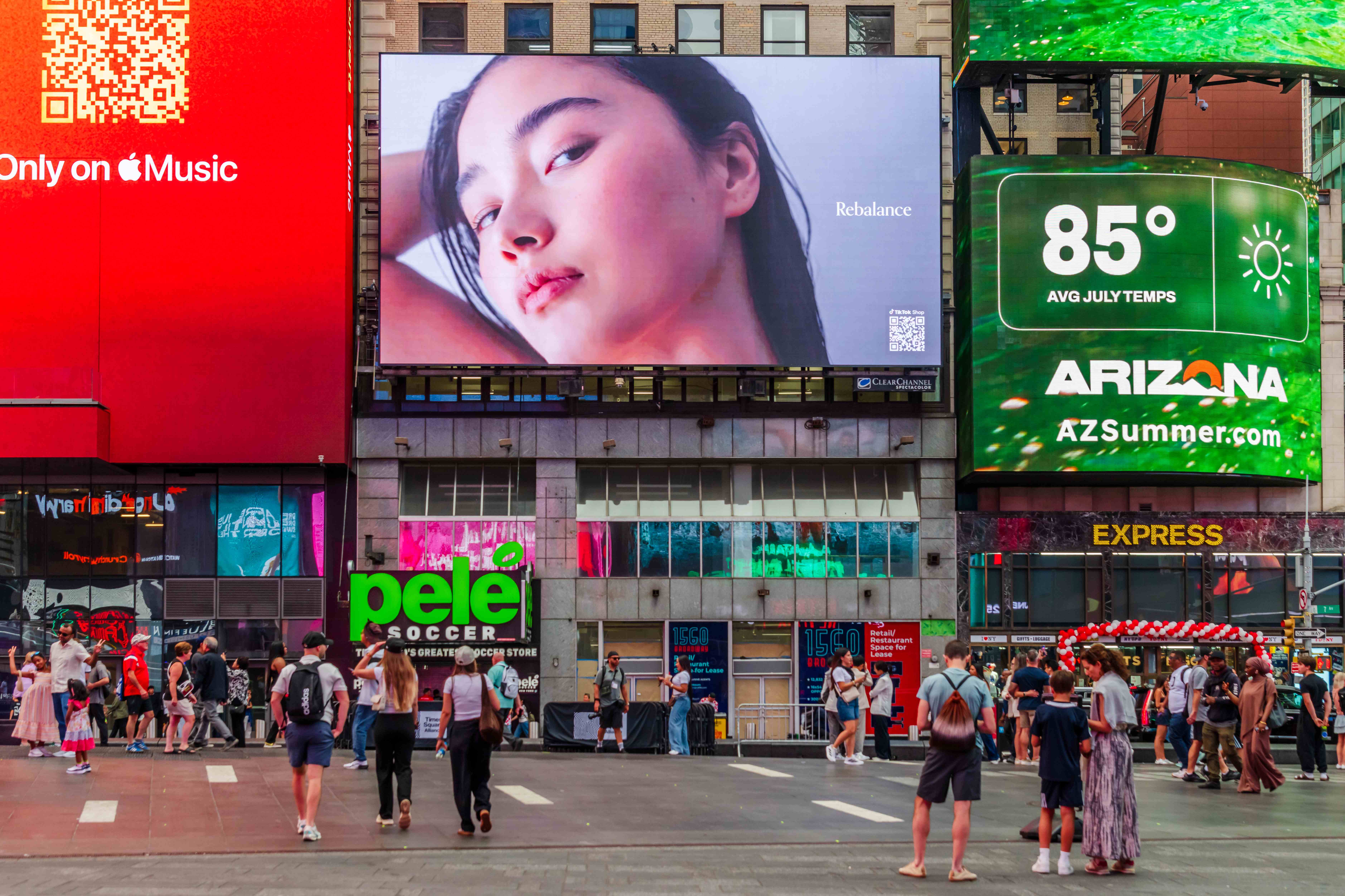 GROWUS "Rebalance" portrait creative on the billboard above pedestrians, surrounded by Times Square digital screens
